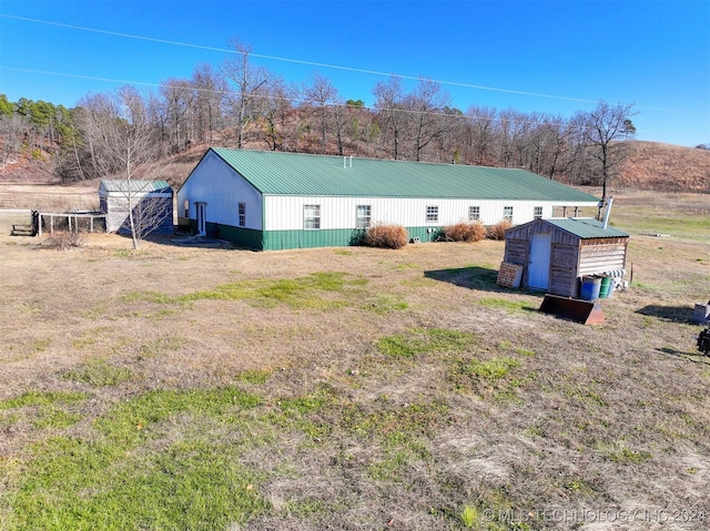 exterior space with a storage unit and a lawn