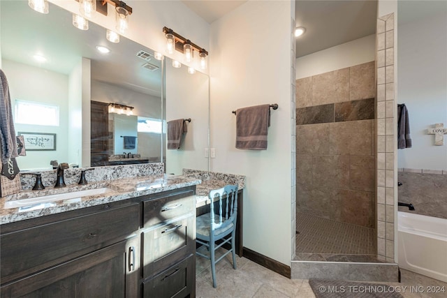 bathroom with tile patterned floors, vanity, and shower with separate bathtub