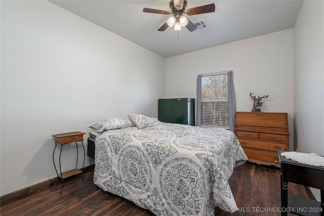 bedroom with dark hardwood / wood-style floors and ceiling fan