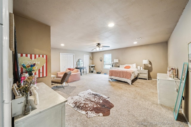 carpeted bedroom with a textured ceiling and ceiling fan