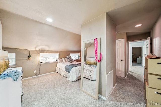 carpeted bedroom with vaulted ceiling