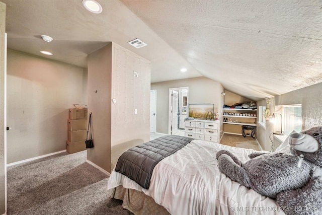 bedroom with a textured ceiling, lofted ceiling, and light carpet