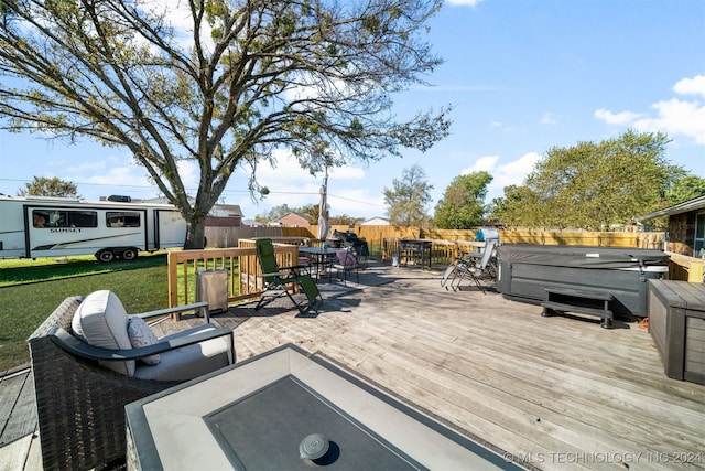 wooden deck with a hot tub