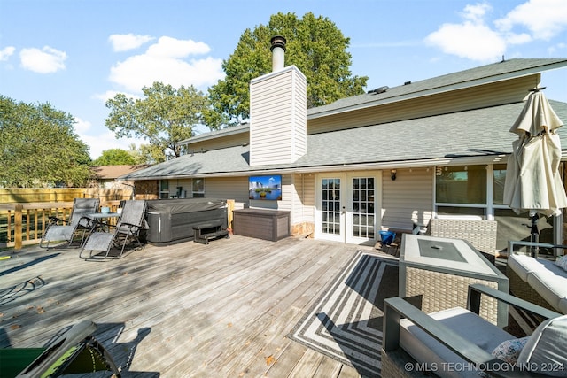 wooden terrace featuring french doors and a hot tub