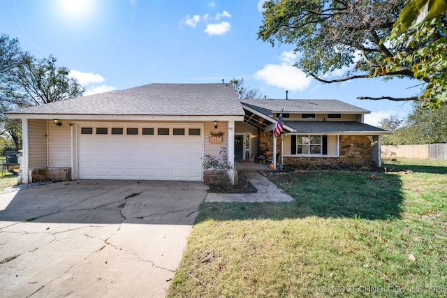 view of front of property with a garage and a front lawn