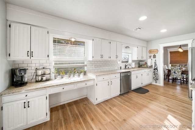 kitchen featuring stainless steel appliances, white cabinetry, and tasteful backsplash