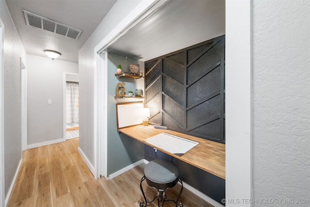 home office with wood-type flooring