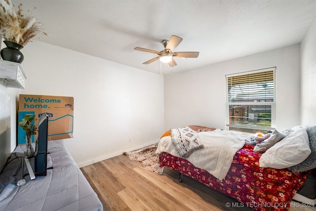 bedroom featuring hardwood / wood-style flooring and ceiling fan