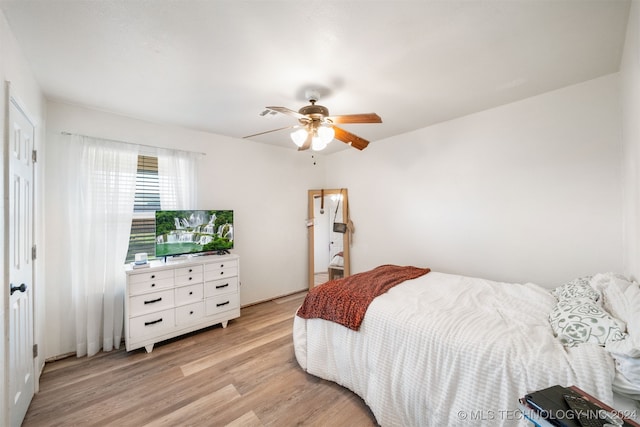 bedroom with light hardwood / wood-style flooring and ceiling fan