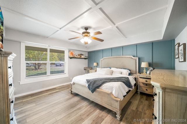 bedroom featuring hardwood / wood-style floors, ceiling fan, and coffered ceiling