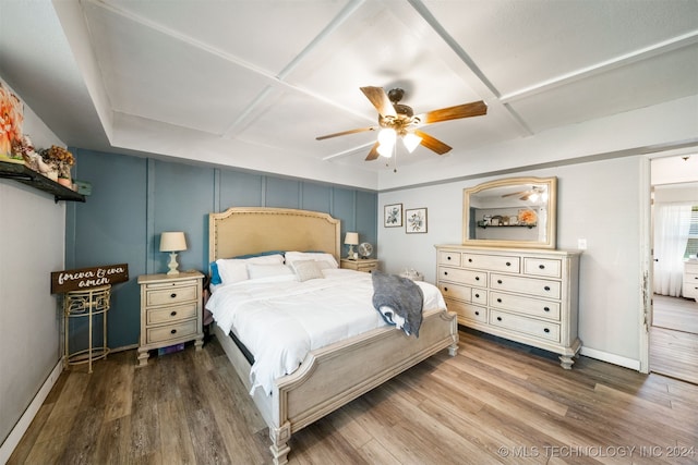 bedroom featuring ceiling fan, wood-type flooring, and coffered ceiling