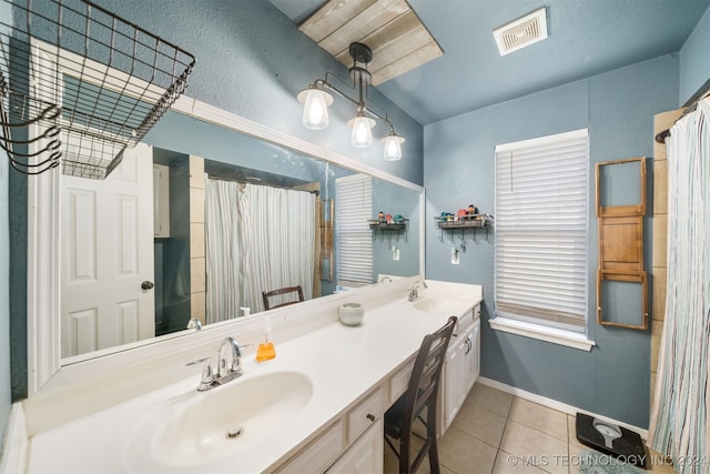 bathroom with tile patterned floors, vanity, and a shower with shower curtain