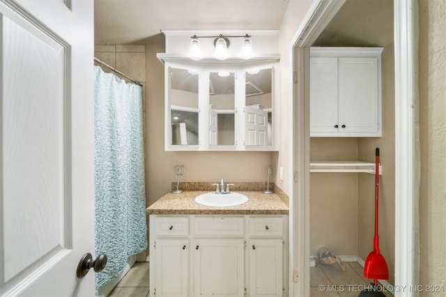 bathroom with tile patterned floors and vanity