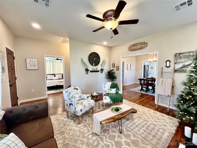 living room with dark hardwood / wood-style floors and ceiling fan