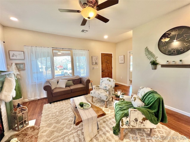 living room featuring ceiling fan and hardwood / wood-style flooring