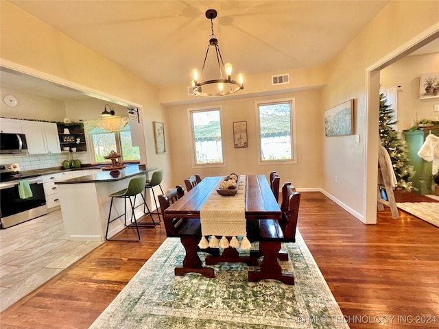 dining room featuring a chandelier and light hardwood / wood-style flooring