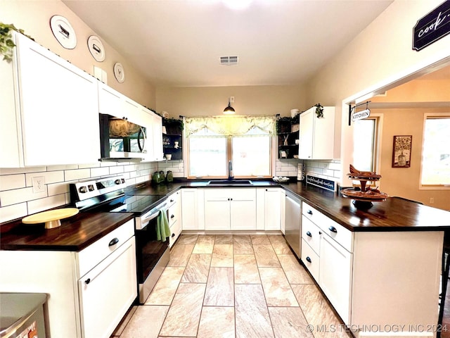 kitchen with white cabinetry, sink, and appliances with stainless steel finishes