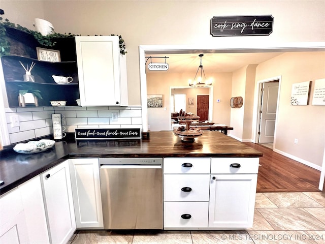 kitchen featuring white cabinetry, backsplash, hanging light fixtures, and a chandelier