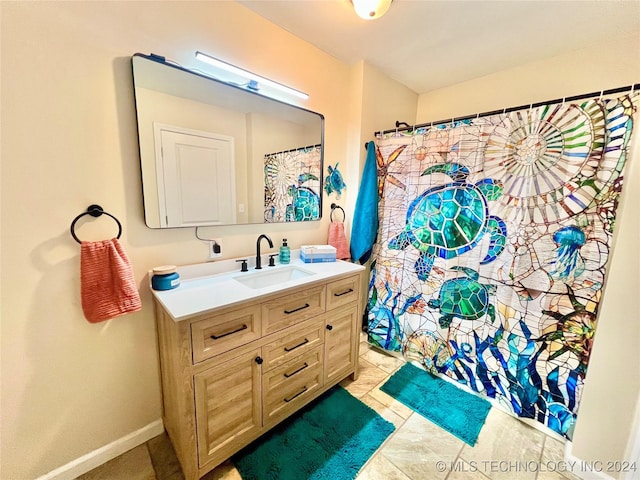 bathroom with tile patterned floors and vanity