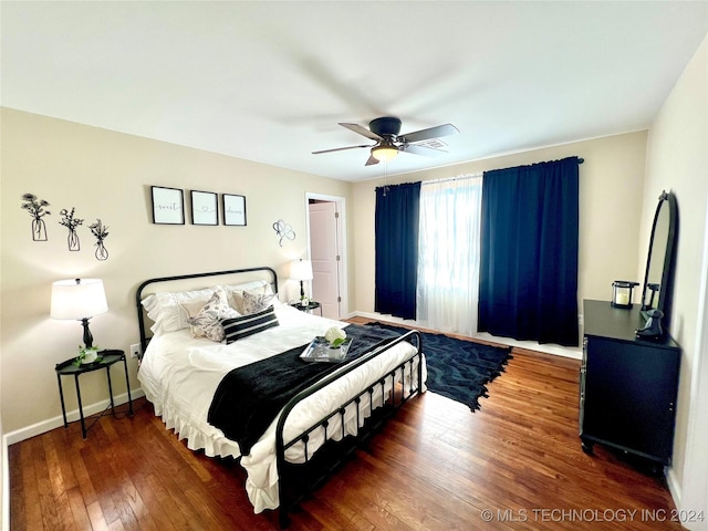 bedroom with ceiling fan and dark hardwood / wood-style floors