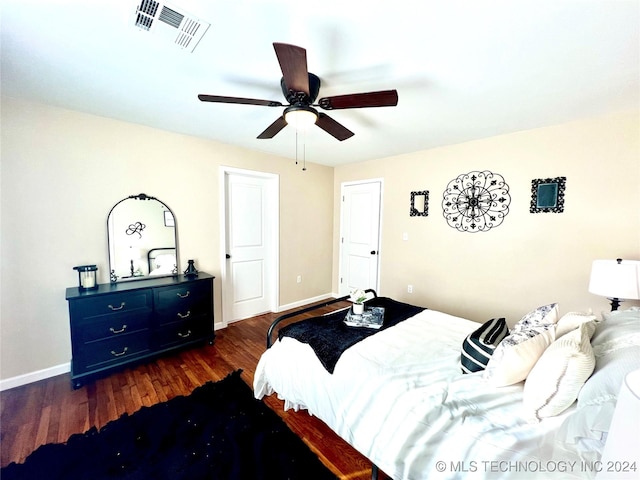 bedroom with ceiling fan and dark wood-type flooring