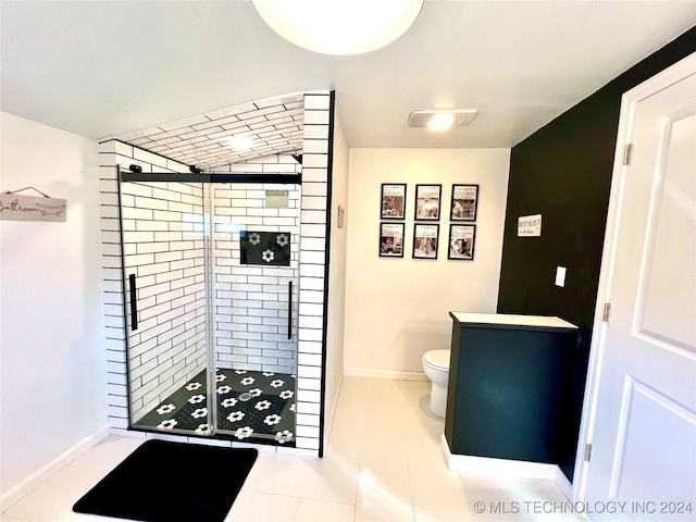 bathroom with tile patterned floors, toilet, and walk in shower