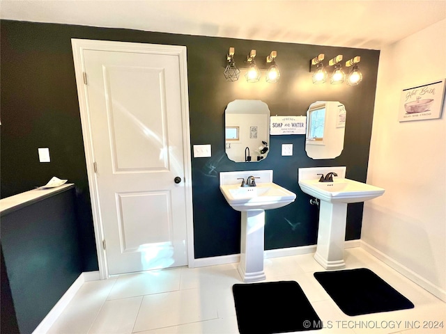 bathroom with tile patterned floors and double sink