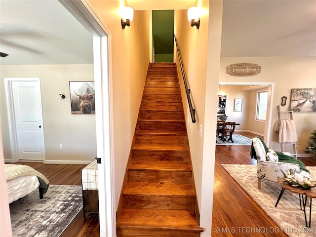 stairway with hardwood / wood-style flooring