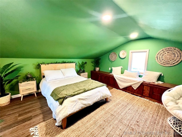 bedroom featuring hardwood / wood-style flooring and vaulted ceiling