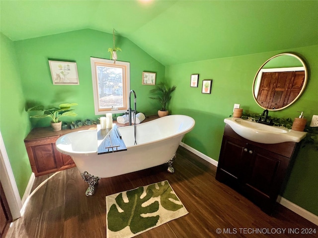 bathroom featuring a bathtub, vanity, wood-type flooring, and lofted ceiling