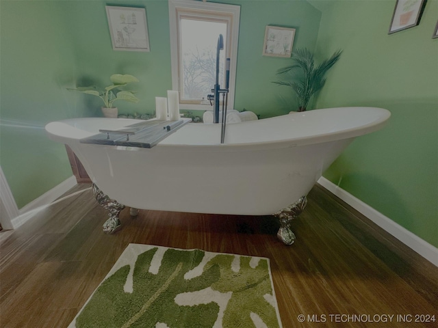 bathroom featuring a bath and hardwood / wood-style floors