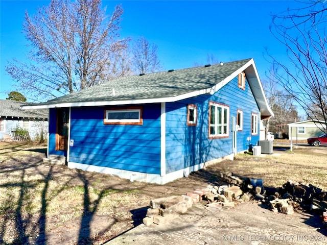 view of side of property with central AC