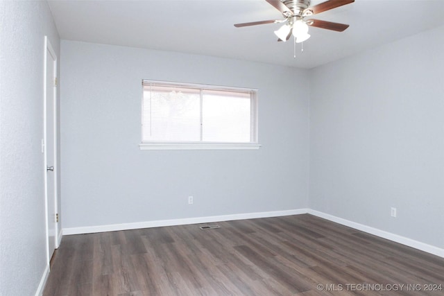 empty room featuring ceiling fan and dark hardwood / wood-style flooring