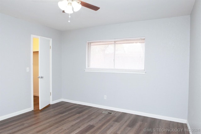 unfurnished room with ceiling fan and dark hardwood / wood-style flooring