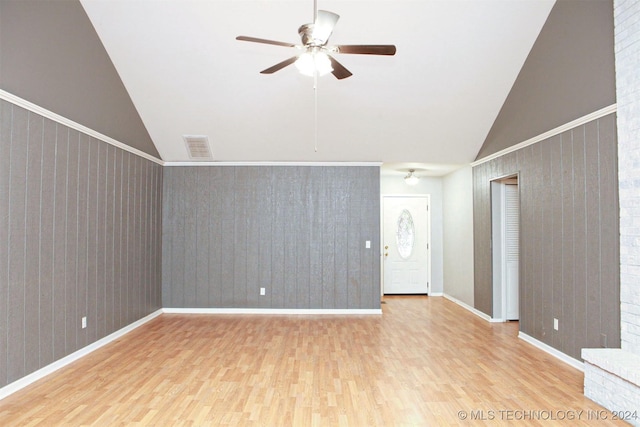 unfurnished living room featuring ceiling fan, high vaulted ceiling, and light wood-type flooring