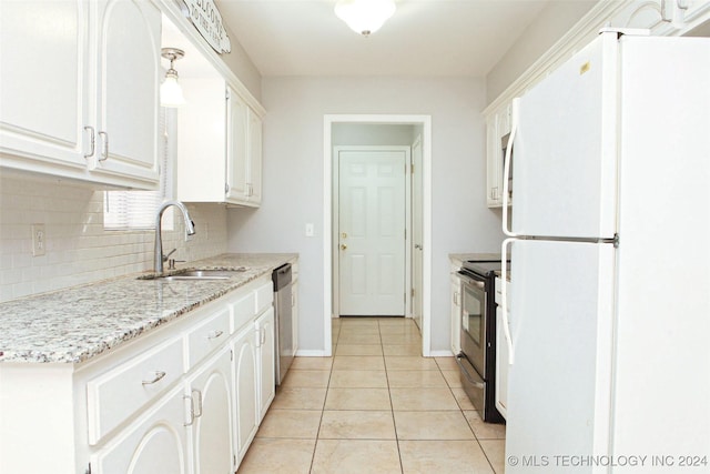 kitchen featuring white cabinetry, sink, black electric range oven, white refrigerator, and light tile patterned floors