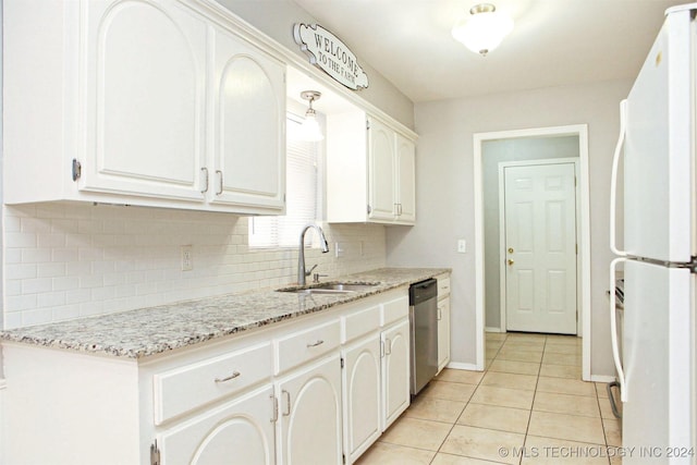 kitchen featuring white cabinets, white fridge, stainless steel dishwasher, and light tile patterned floors