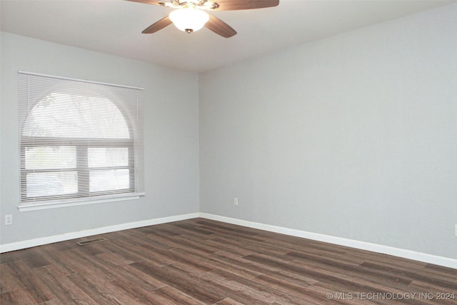 unfurnished room featuring ceiling fan and dark wood-type flooring