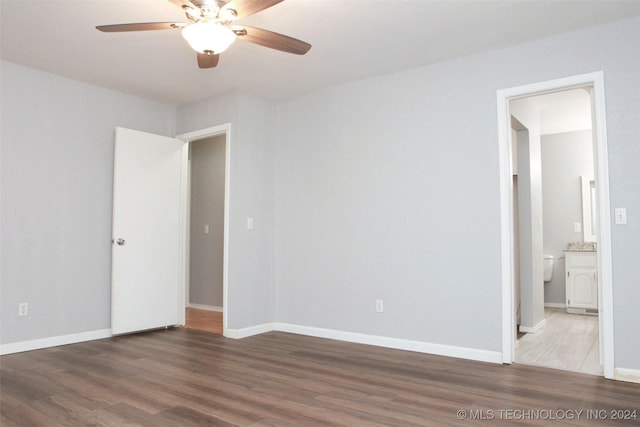 empty room with dark hardwood / wood-style floors and ceiling fan