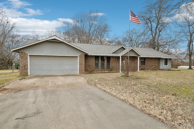 single story home with a garage and a front lawn