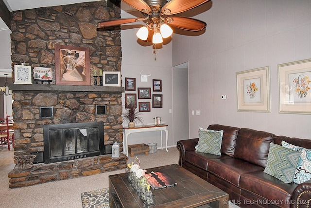 carpeted living room with ceiling fan, a fireplace, and vaulted ceiling