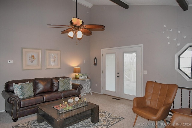 carpeted living room with ceiling fan, lofted ceiling with beams, and french doors