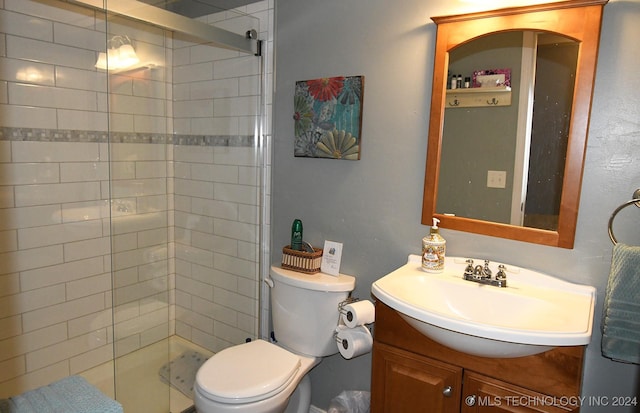 bathroom featuring vanity, toilet, and walk in shower