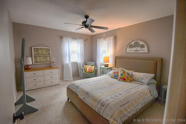 bedroom with light colored carpet and ceiling fan