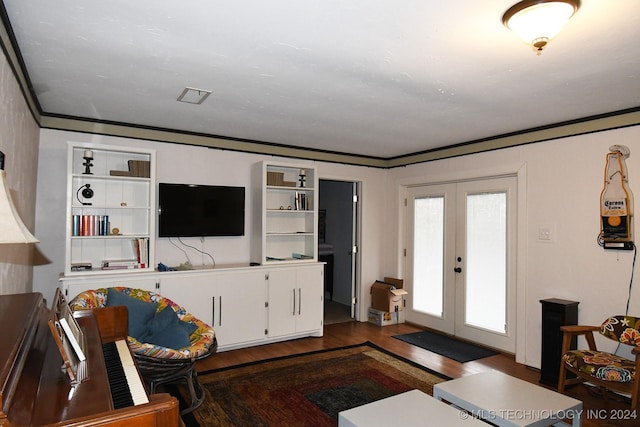 living room with crown molding, french doors, and dark wood-type flooring