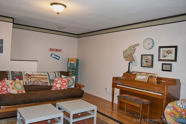 living room featuring wood-type flooring and ornamental molding