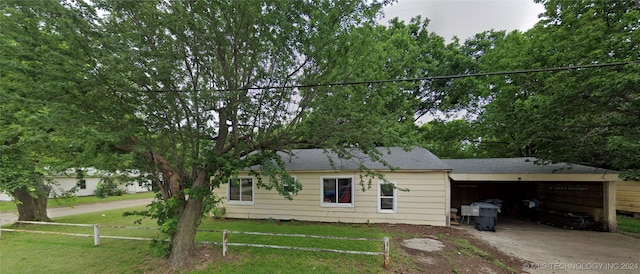 view of front facade with a carport and a front yard