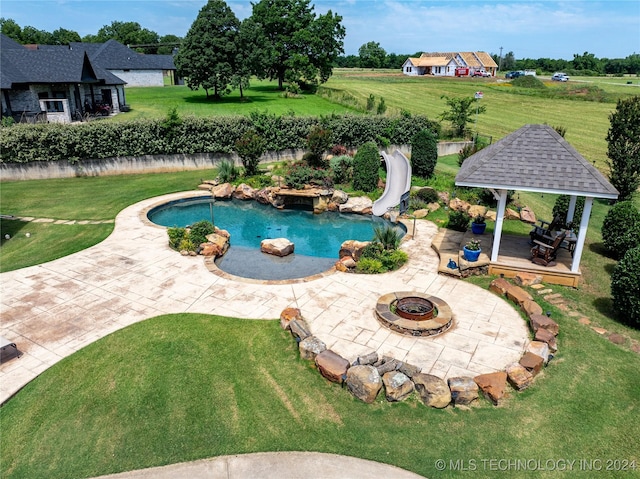 view of swimming pool with a gazebo, a lawn, a patio, and an outdoor fire pit