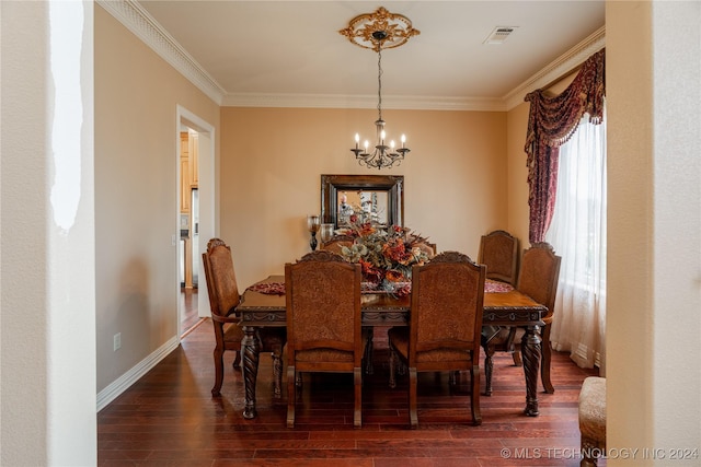 dining space featuring dark wood-type flooring, crown molding, and a notable chandelier