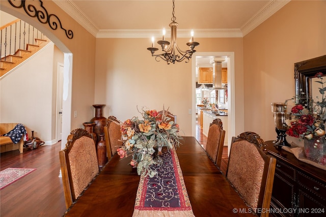 dining room featuring a chandelier, ornamental molding, and dark wood-type flooring